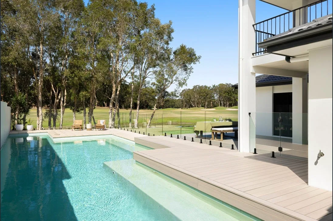 Frameless glass pool fencing beside a golf course property