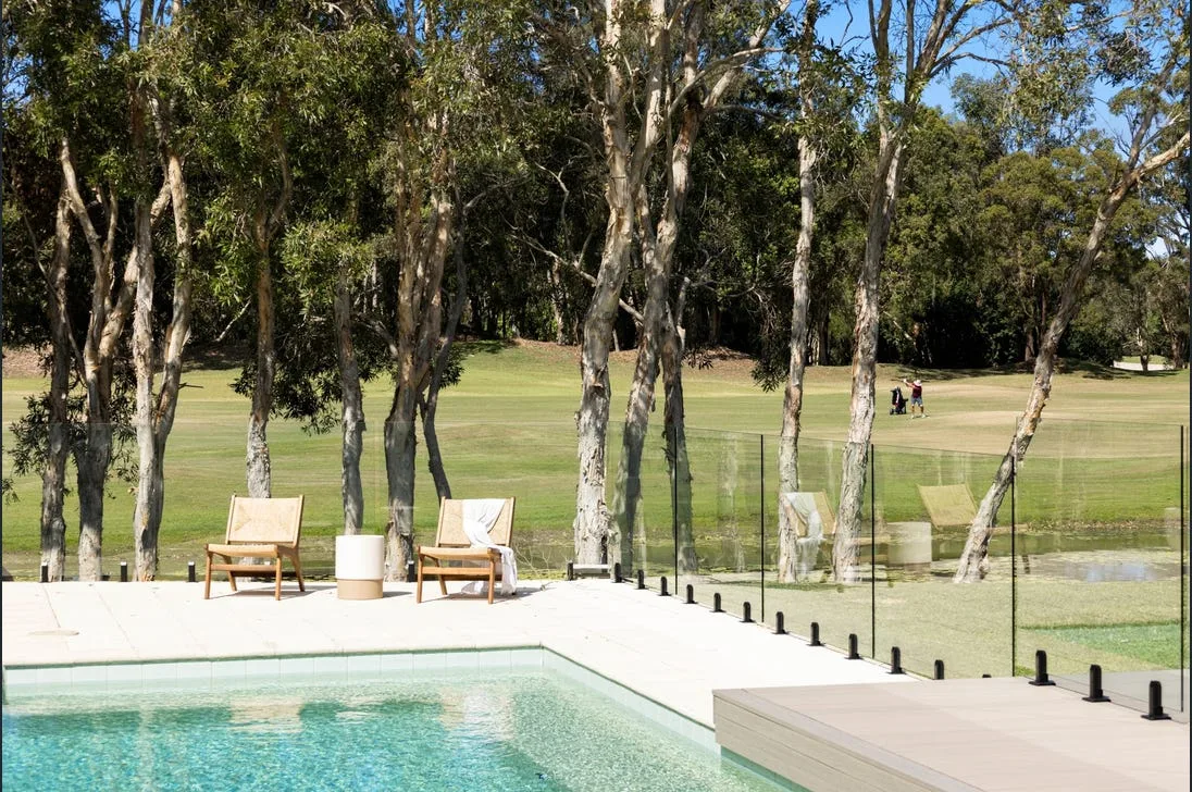 Frameless glass pool fencing beside a bushland pool