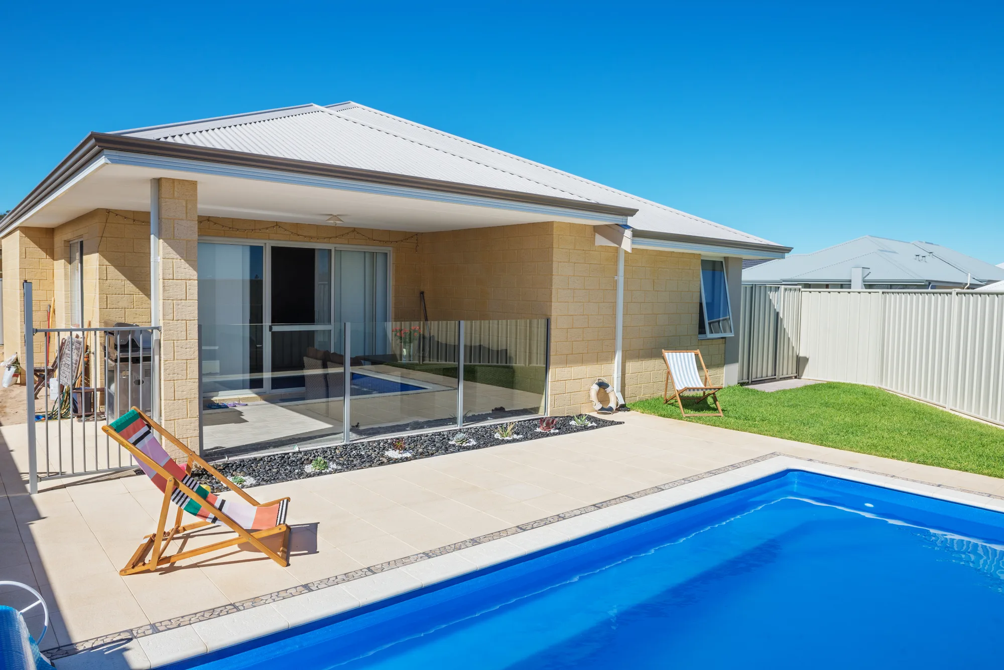 Glass pool fencing installed around a home pool