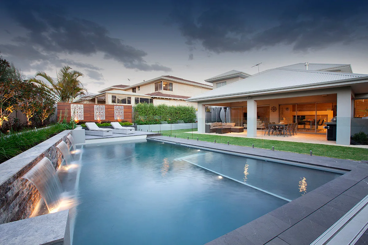 Pool with a waterfall feature and glass balustrade edge